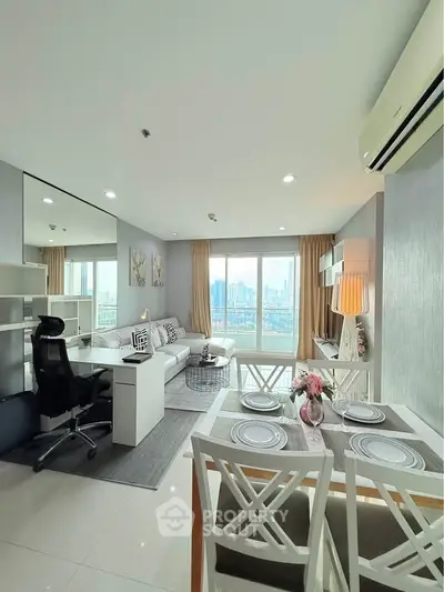 Modern living room with city view, stylish furniture, and dining area in a bright apartment.