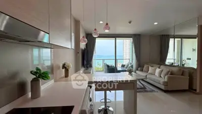 Modern open-layout living room with ocean view and stylish kitchen