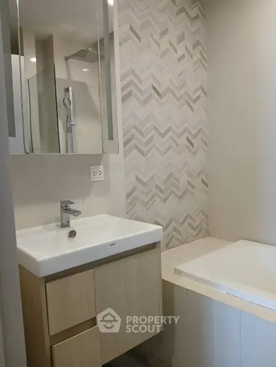 Modern bathroom with stylish sink and bathtub in contemporary apartment