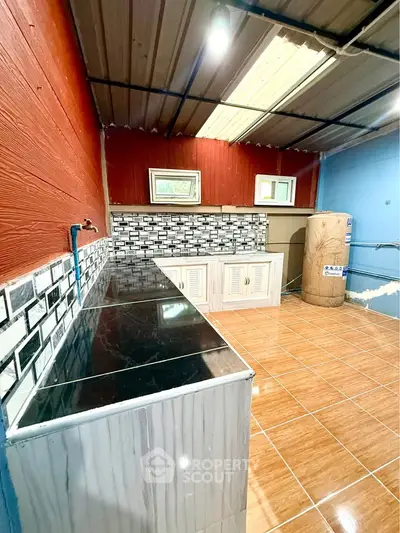 Unique kitchen space with tiled countertops and rustic ceiling design