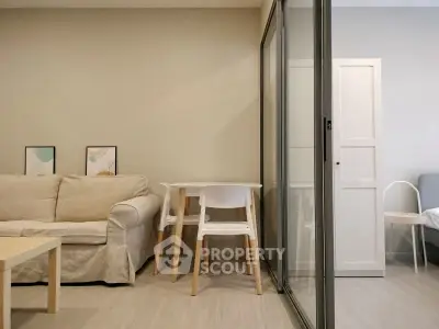 Modern living room with cozy sofa and dining area in open layout apartment.