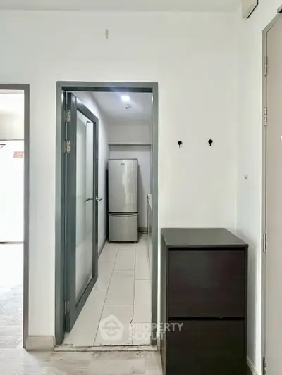 Modern kitchen entrance with sleek fridge and minimalist design