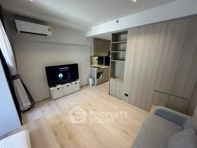 Modern living room with sleek wooden cabinetry and cozy sofa in stylish apartment