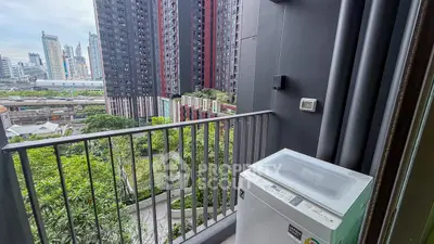 Urban balcony with washing machine and city skyline view