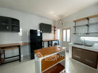 Spacious kitchen with modern appliances and ample storage in a bright, airy setting.