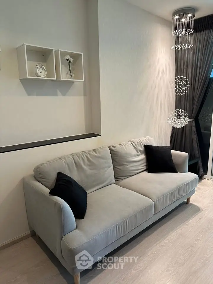 Modern living room with stylish sofa and elegant lighting, perfect for cozy relaxation.