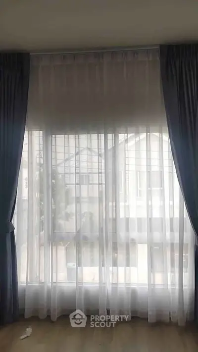 Elegant window with sheer curtains offering a soft, natural light ambiance in a modern living space.