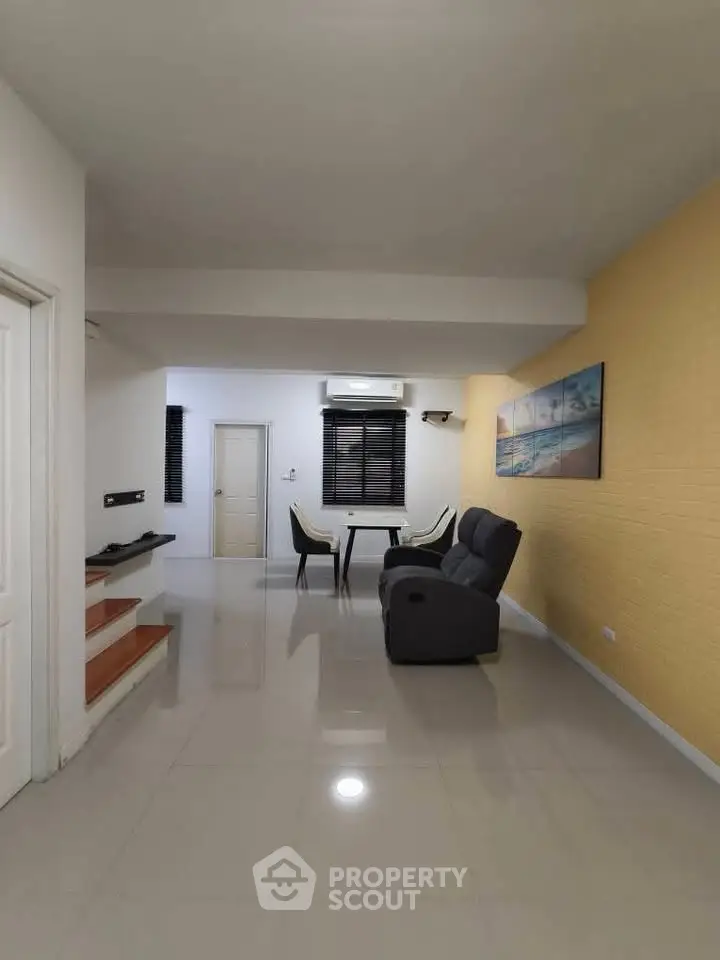 Spacious living room with modern decor and comfortable seating, perfect for relaxation and entertainment.