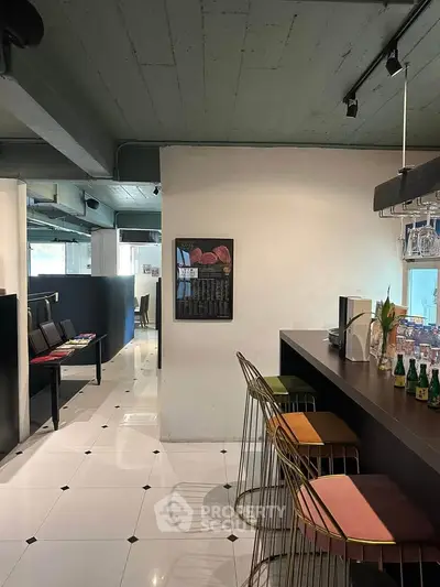 Modern dining area with stylish bar stools and sleek decor, perfect for entertaining guests.