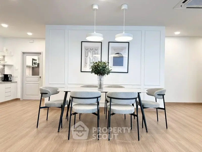 Modern dining area with elegant decor and stylish lighting in a contemporary home.