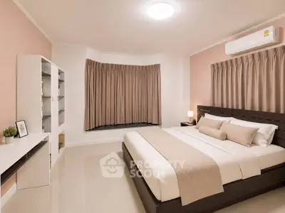Spacious modern bedroom with elegant decor and natural lighting