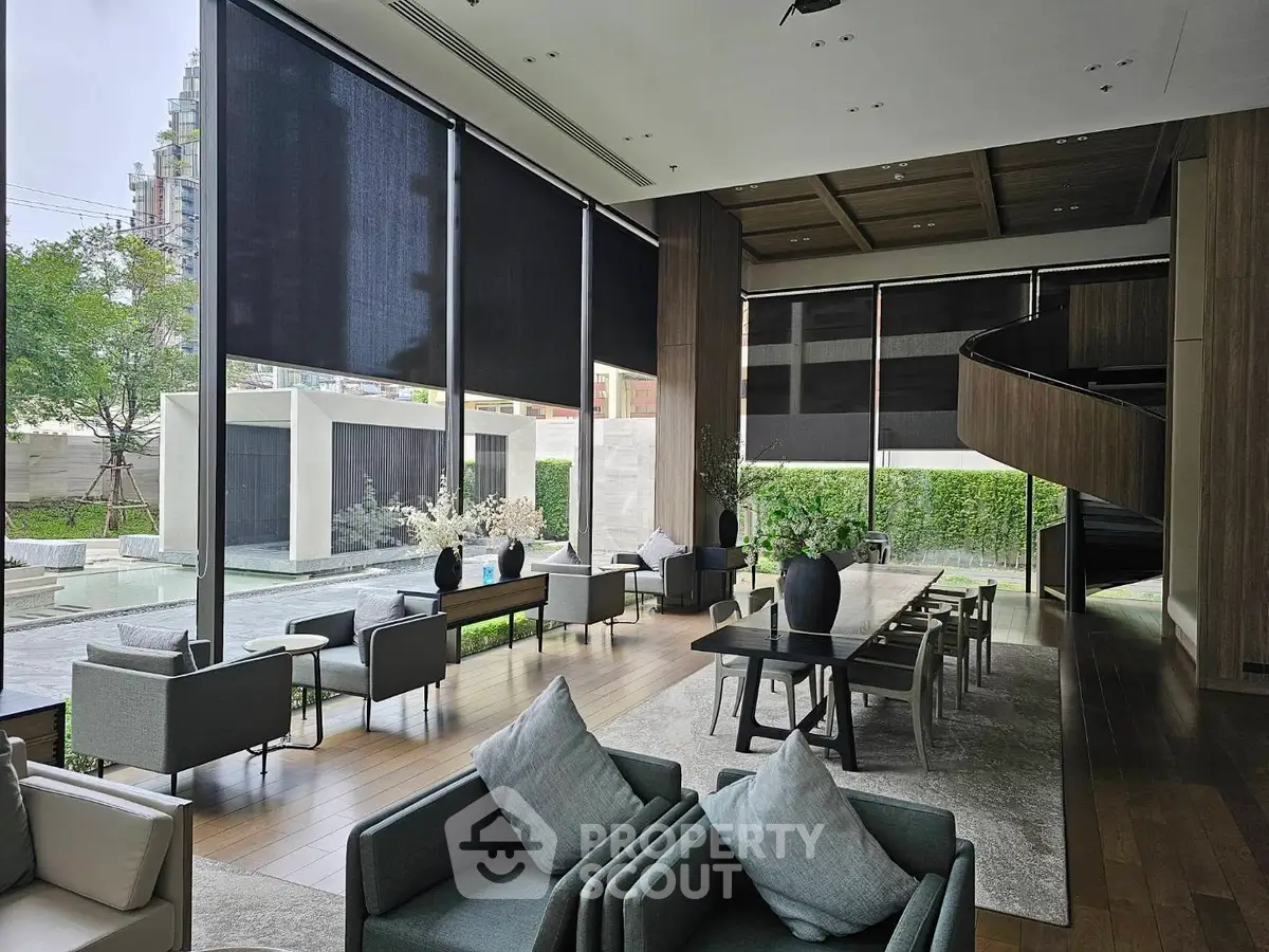 Luxurious modern lobby with floor-to-ceiling windows and elegant furnishings, perfect for upscale living.