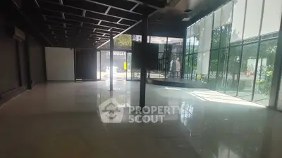 Spacious modern commercial space with large glass windows and sleek design.