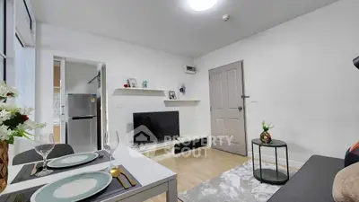 Modern living room with sleek decor and open layout, featuring a cozy seating area and stylish dining setup.