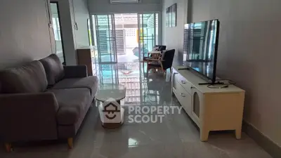 Spacious living room with modern furniture and large windows for natural light.