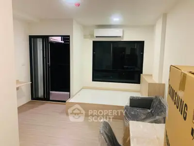 Modern unfurnished living room with air conditioning and balcony access