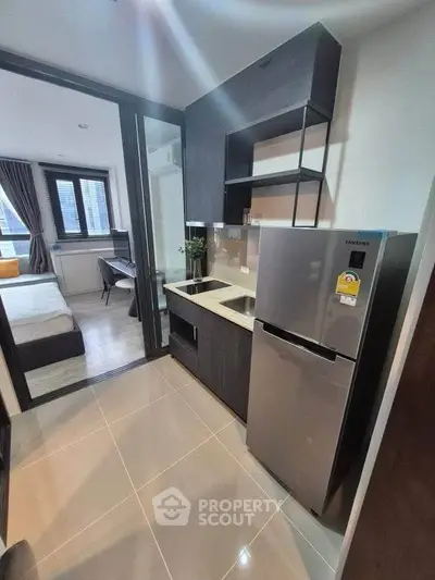 Modern compact kitchen with sleek appliances and open layout in stylish apartment