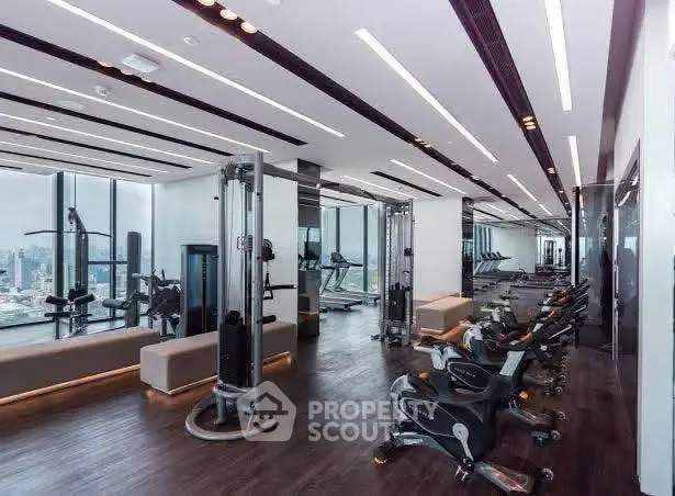 Luxurious high-rise gym with panoramic city views and modern fitness equipment.