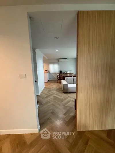 Modern living room with herringbone wood flooring and stylish decor