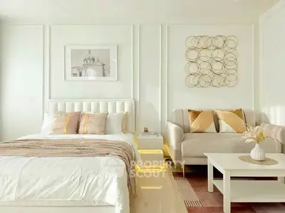Luxurious bedroom with elegant decor and cozy seating area, perfect for relaxation.