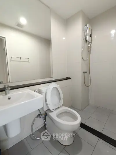 Modern bathroom with sleek fixtures and a spacious shower area, perfect for contemporary living.