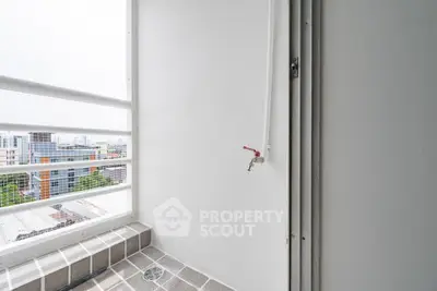 Compact balcony with city view and safety railing in modern apartment