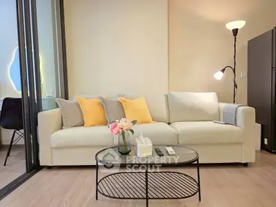 Modern living room with cozy sofa and stylish decor in a bright apartment.