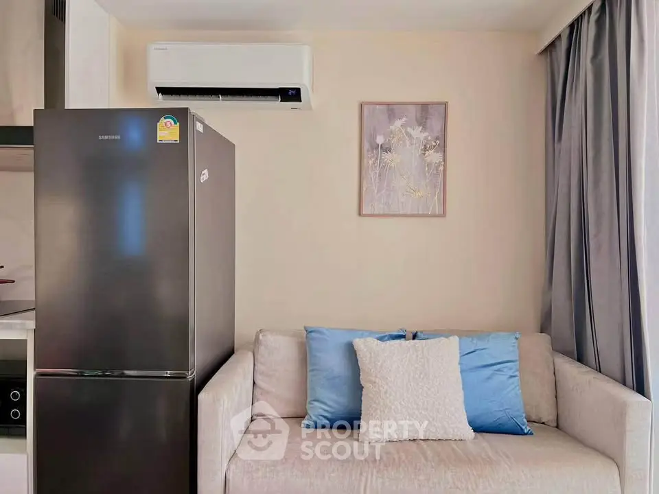 Cozy living room with modern fridge and air conditioning unit