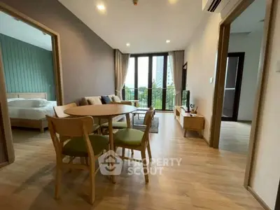 Modern open-plan living room with dining area and balcony view