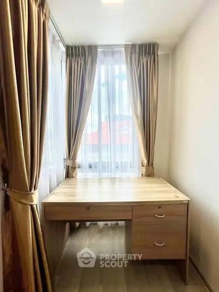 Cozy study room with natural light and elegant curtains