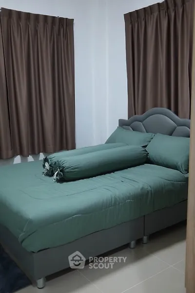 Cozy bedroom with elegant curtains and plush bedding for ultimate comfort.