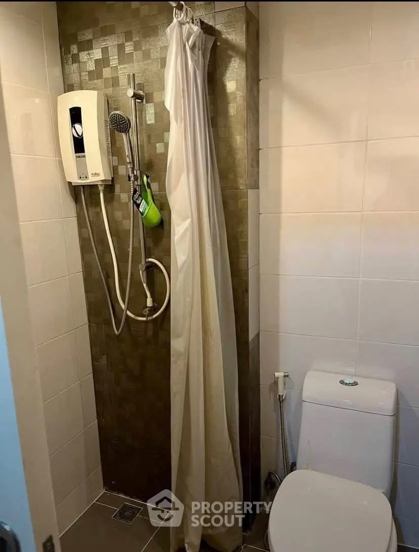 Compact bathroom with shower and toilet in modern apartment