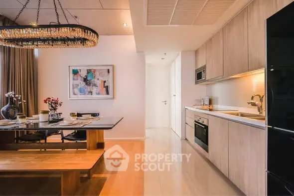 Modern kitchen and dining area with elegant lighting and contemporary decor.