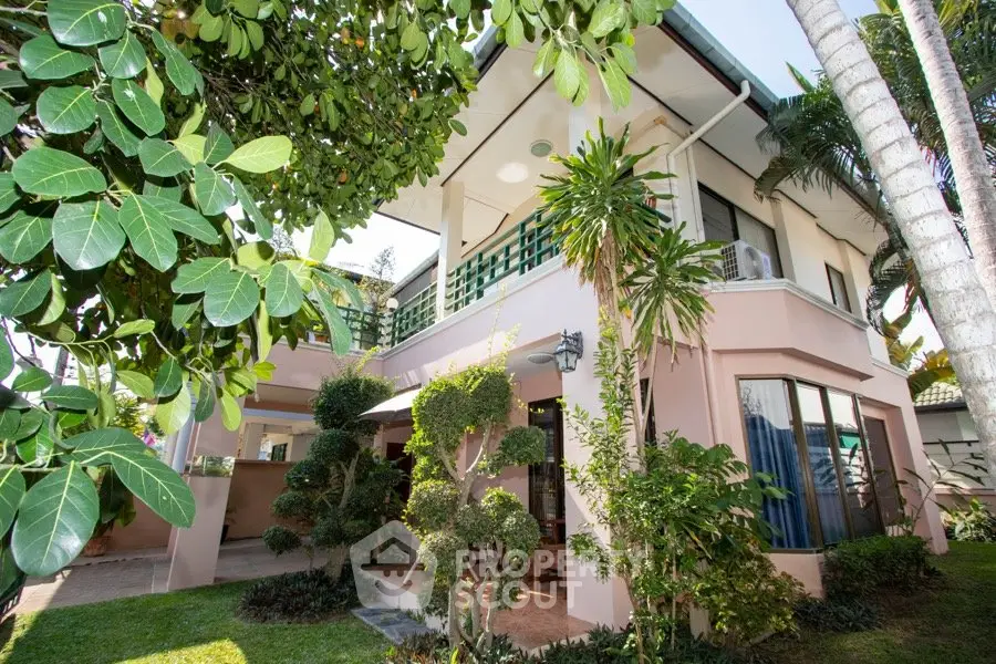 Charming two-story house with lush garden and modern architecture