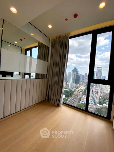 Modern high-rise apartment with floor-to-ceiling windows offering stunning city views and elegant interior design.