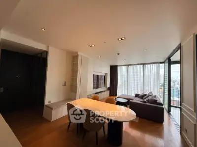 Spacious modern living room with city view, featuring elegant furniture and natural light.