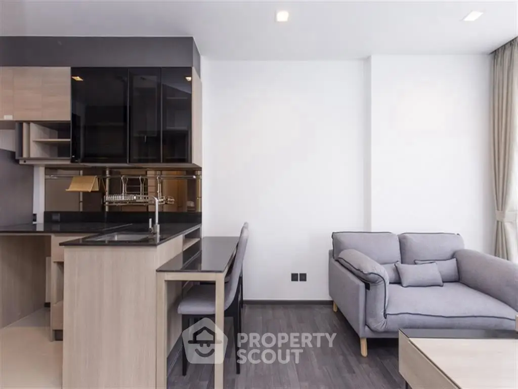 Modern open-layout kitchen and living room with sleek design and neutral tones.