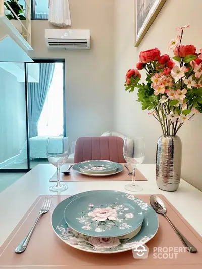 Elegant dining setup with floral plates and modern decor in a stylish apartment