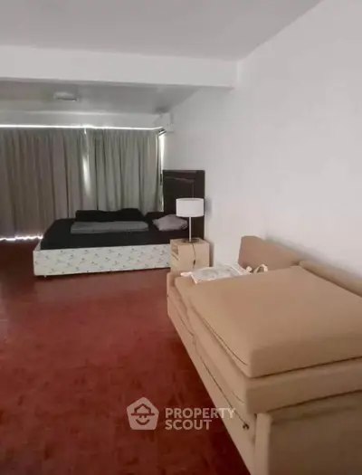 Spacious bedroom with modern furnishings and ample natural light