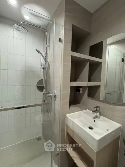 Modern bathroom with sleek shower and stylish sink in contemporary design.