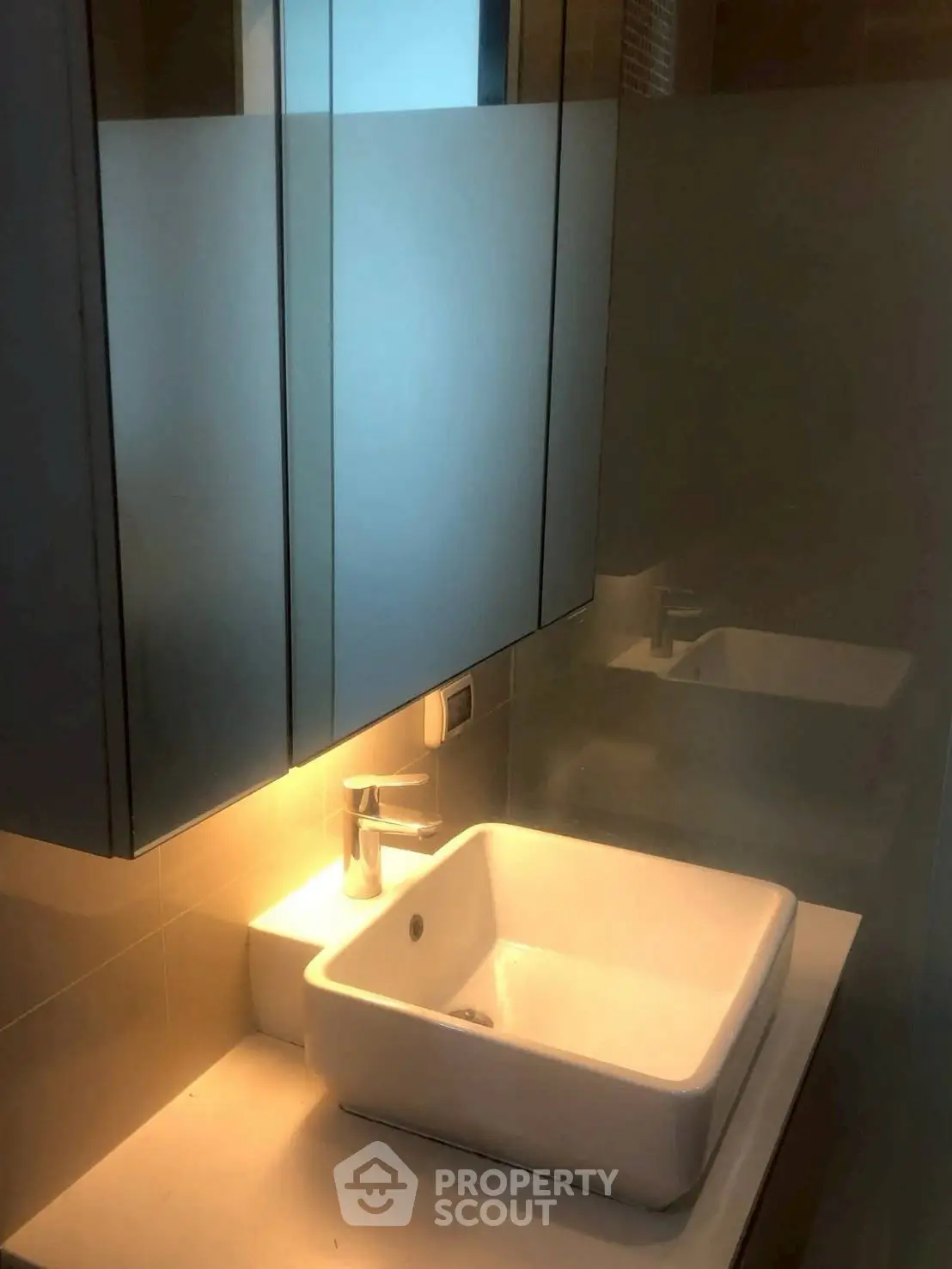 Modern bathroom with sleek sink and mirrored cabinet, perfect for contemporary living.