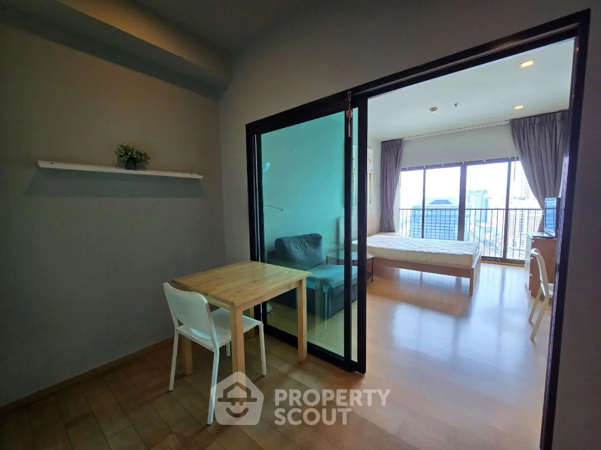 Modern studio apartment with open layout and city view balcony