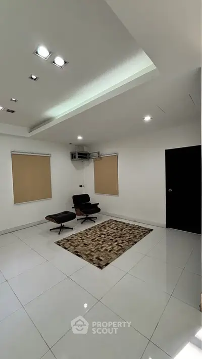 Modern minimalist living room with sleek furniture and bright lighting