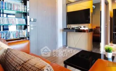 Modern living room with leather sofa and entertainment center, featuring sleek decor and wooden flooring.