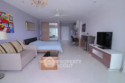 Modern studio apartment with open layout, featuring a cozy living area and stylish kitchen.