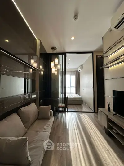 Modern living room with stylish decor and open view to bedroom