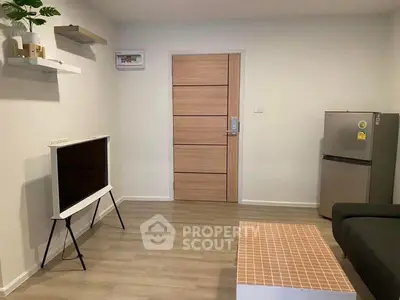 Modern living room with sleek design, featuring a stylish TV stand and compact fridge, perfect for urban living.