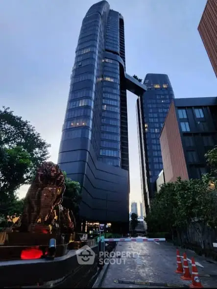 Stunning modern high-rise building with unique architecture and lush surroundings.