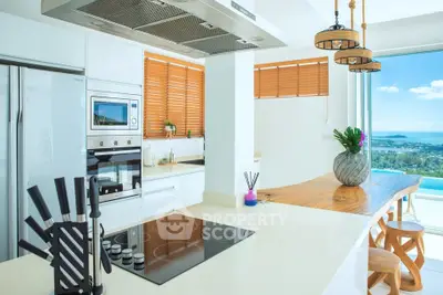 Stunning modern kitchen with ocean view, sleek appliances, and elegant wooden accents.