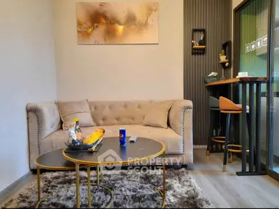 Stylish living room with modern decor, plush sofa, and chic coffee tables, perfect for relaxation and entertaining.